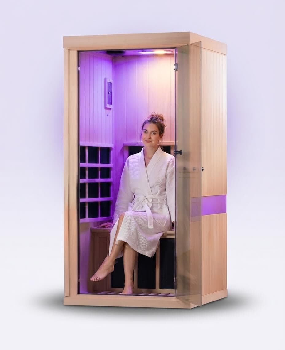 A single-person infrared sauna cubicle with soft purple light inside